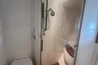 Bathroom interior of a 2005 Pershing 76 yacht with shower and toilet.