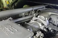 Engine compartment of a 2005 Pershing 76 yacht, showcasing mechanical components and wiring.