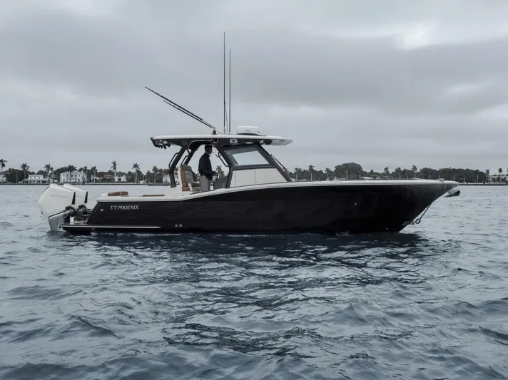 T/t Phoenix Yacht Photos Pics 2023 Scout 330 LXF boat on water, overcast sky, side view.