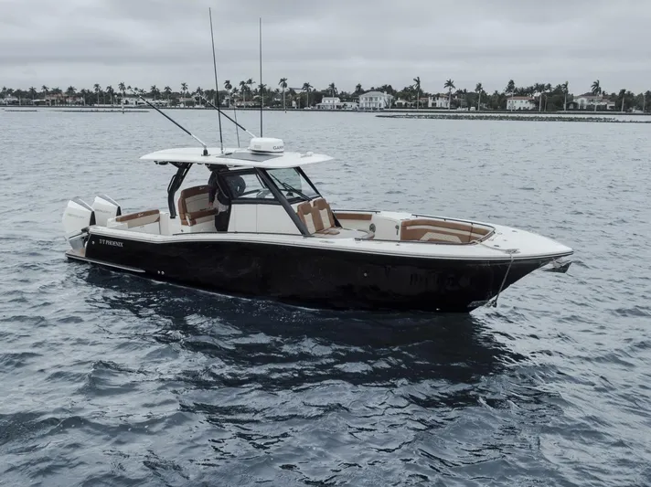 T/t Phoenix Yacht Photos Pics 2023 Scout 330 LXF boat on water, overcast sky, coastal background.
