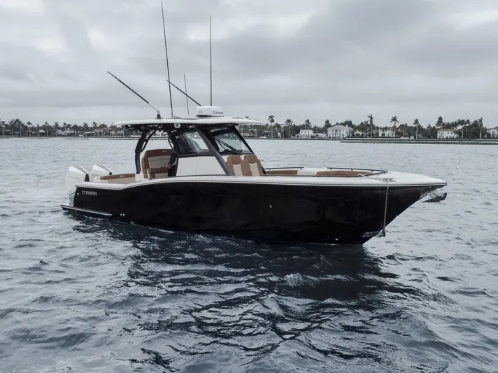 T/t Phoenix Yacht Photos Pics 2023 Scout 330 LXF boat on water, overcast sky, coastal background.