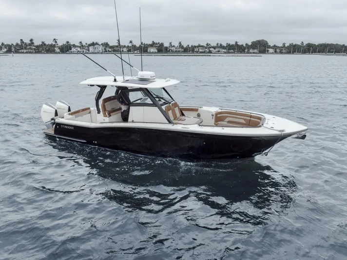 T/t Phoenix Yacht Photos Pics 2023 Scout 330 LXF boat on calm water, featuring sleek design and modern amenities.