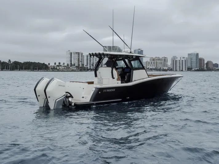 T/t Phoenix Yacht Photos Pics 2023 Scout 330 LXF boat on water with city skyline background.