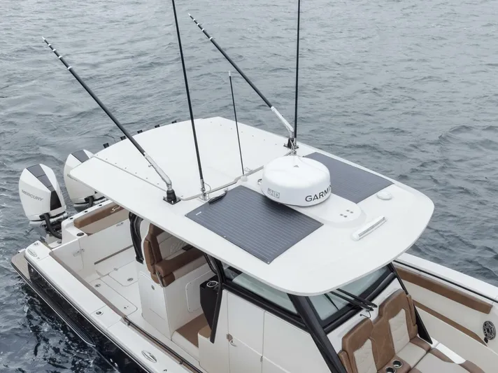 T/t Phoenix Yacht Photos Pics 2023 Scout 330 LXF boat with fishing rods and Garmin equipment on the water.