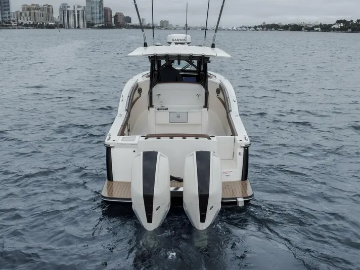 T/t Phoenix Yacht Photos Pics 2023 Scout 330 LXF boat on water, rear view with twin engines.