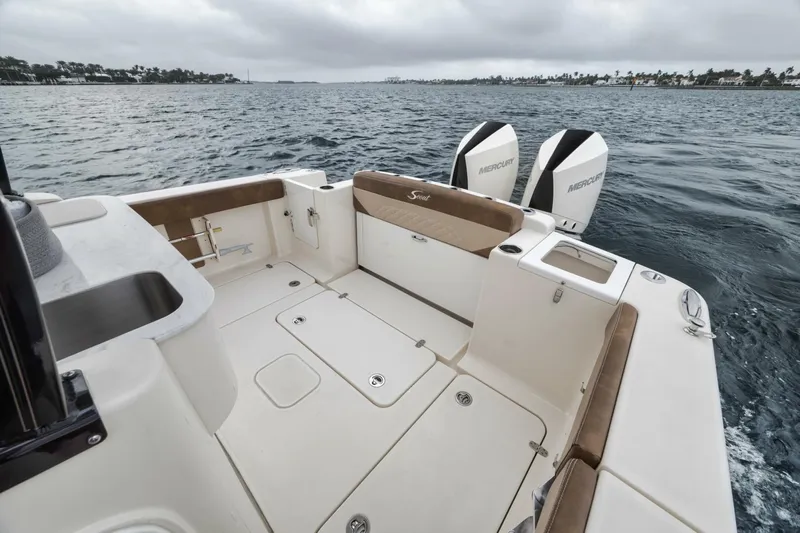 T/t Phoenix Yacht Photos Pics 2023 Scout 330 LXF boat deck with dual outboard motors on the water.