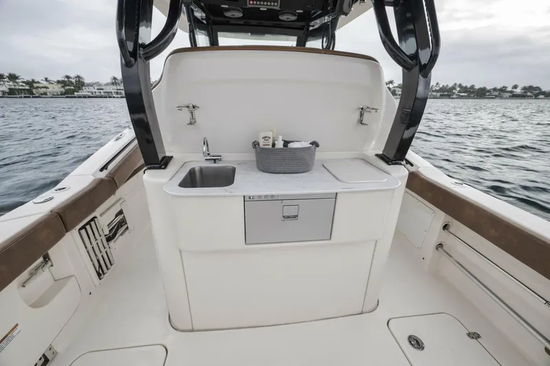 T/t Phoenix Yacht Photos Pics 2023 Scout 330 LXF boat interior with sink and storage on deck.