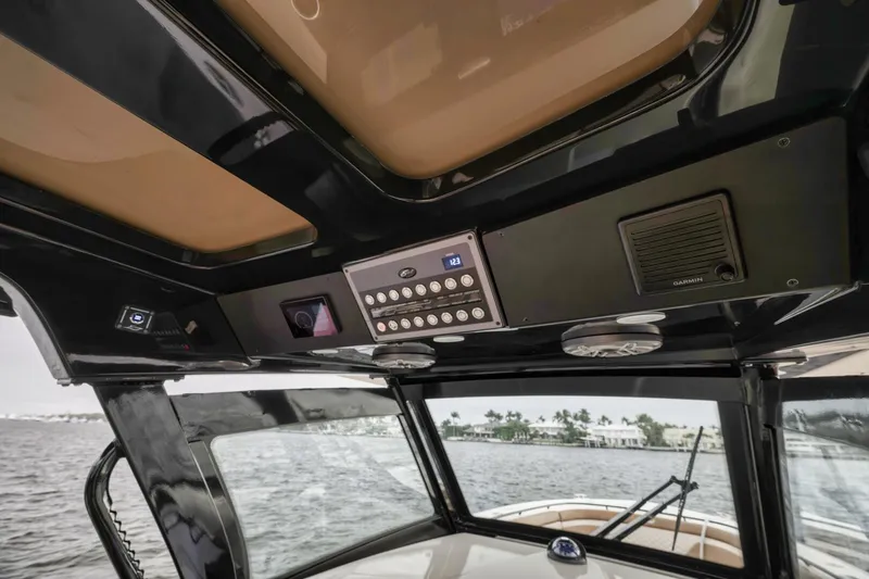 T/t Phoenix Yacht Photos Pics 2023 Scout 330 LXF boat interior dashboard with control panel and scenic water view.
