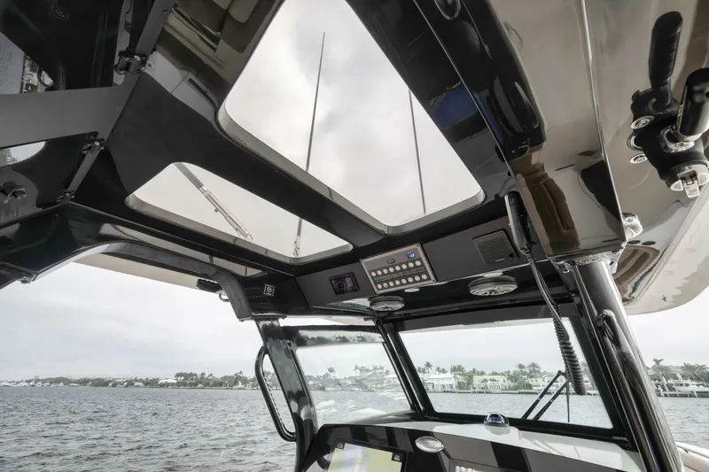 T/t Phoenix Yacht Photos Pics 2023 Scout 330 LXF boat interior with panoramic roof and control panel.