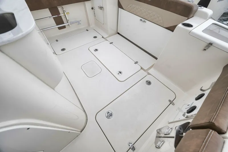 T/t Phoenix Yacht Photos Pics 2023 Scout 330 LXF boat interior with storage compartments and seating.