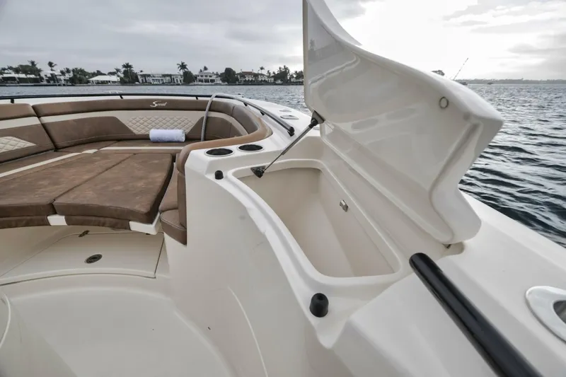 T/t Phoenix Yacht Photos Pics 2023 Scout 330 LXF boat interior with open storage compartment and seating area.