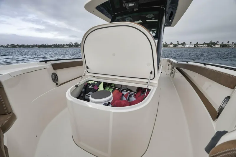 T/t Phoenix Yacht Photos Pics 2023 Scout 330 LXF boat with open storage compartment, showing gear inside.