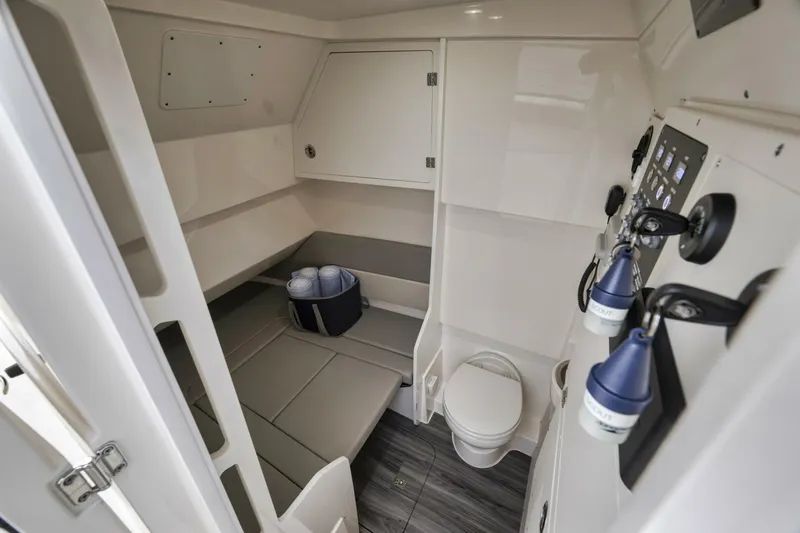 T/t Phoenix Yacht Photos Pics 2023 Scout 330 LXF cabin interior with seating, toilet, and control panel.