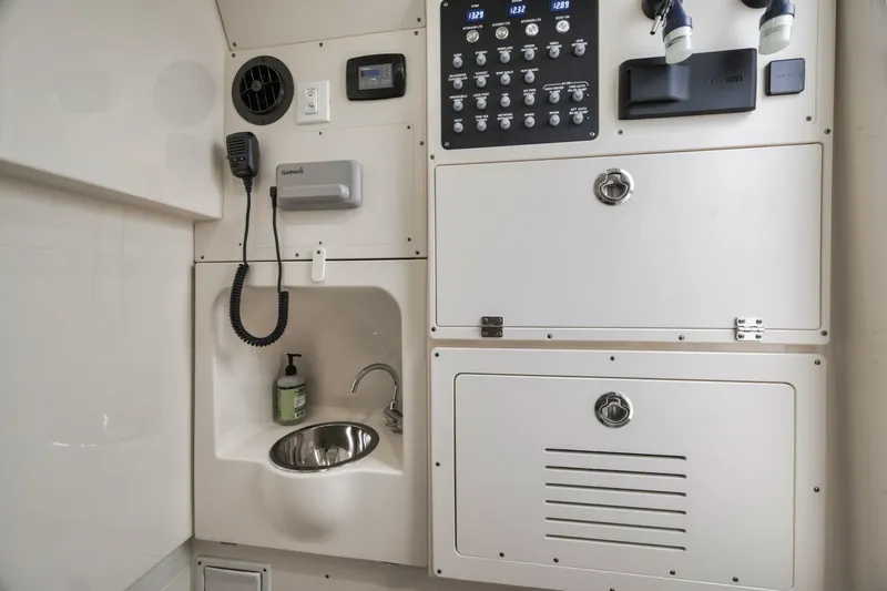 T/t Phoenix Yacht Photos Pics 2023 Scout 330 LXF boat interior with control panel and sink.