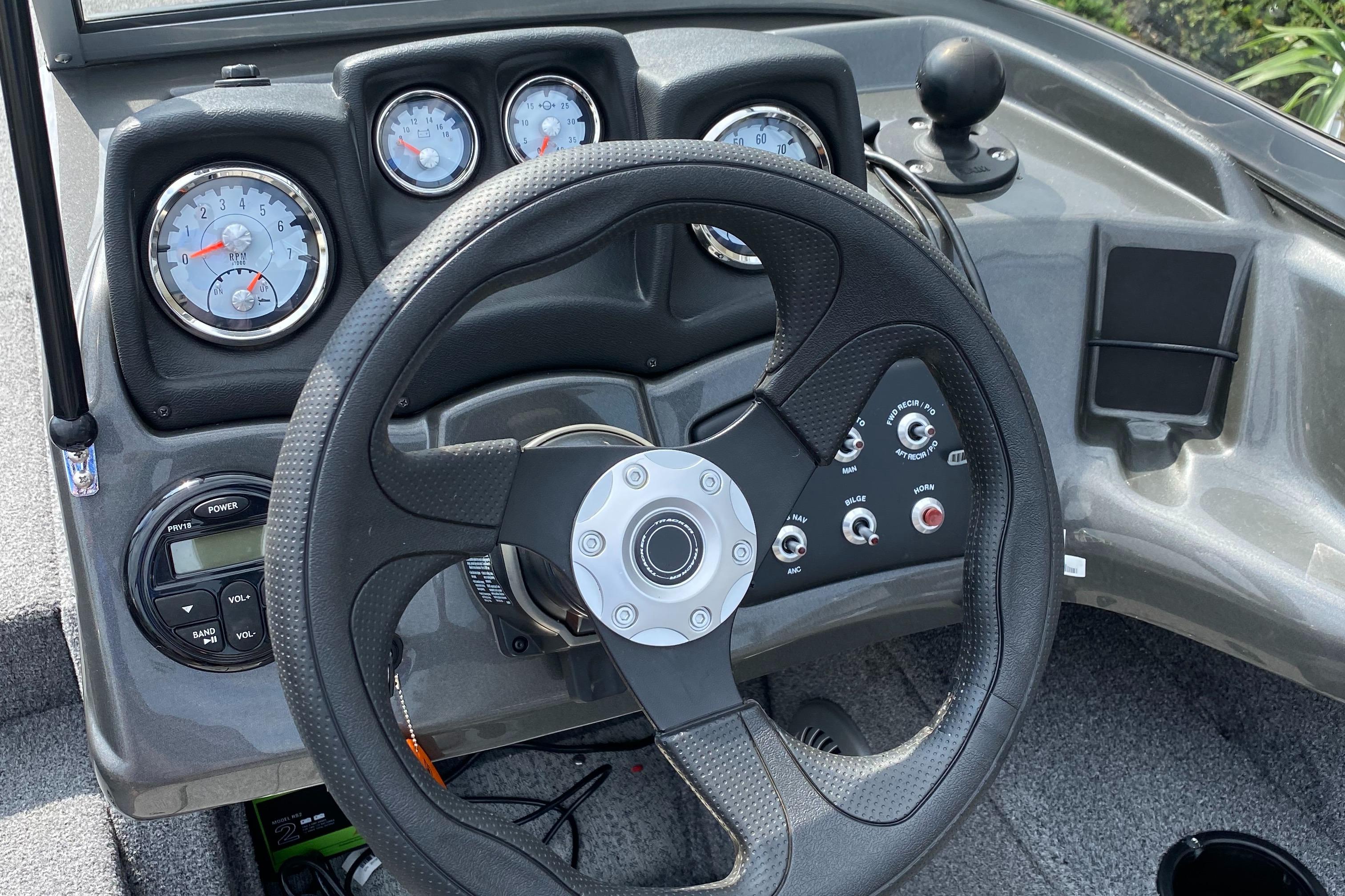 2020 Tracker Pro Guide V175 boat dashboard with steering wheel and gauges.