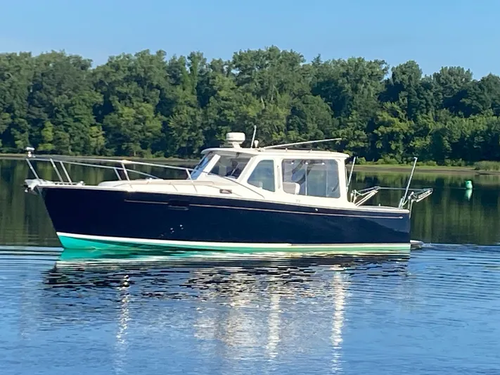 Saline Yacht Photos Pics 2005 MJM 34z Downeast boat on calm water with forested background.