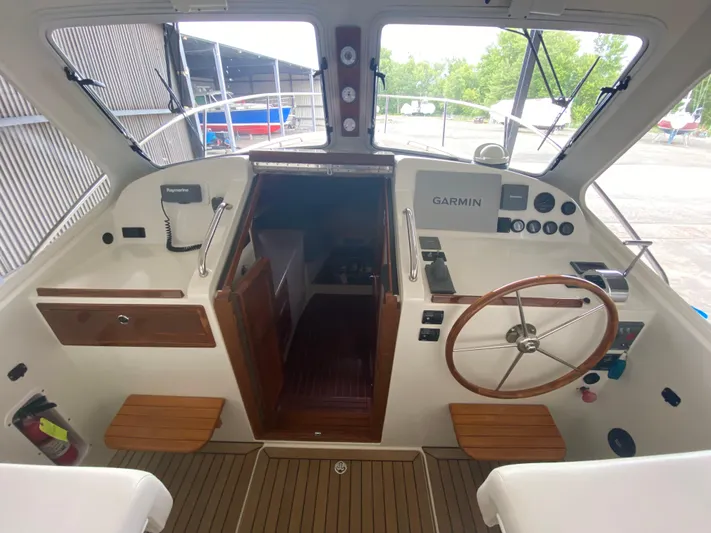 Saline Yacht Photos Pics 2005 MJM 34z Downeast boat cockpit with Garmin navigation and wooden steering wheel.
