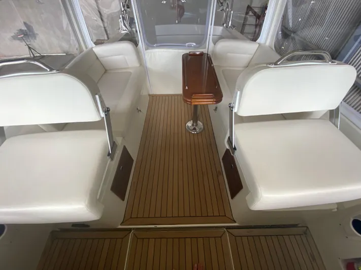 Saline Yacht Photos Pics 2005 MJM 34z Downeast boat interior with white seating and wooden flooring.