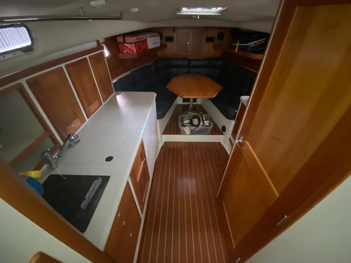 Saline Yacht Photos Pics Interior of 2005 MJM 34z Downeast boat with wood cabinetry and seating area.