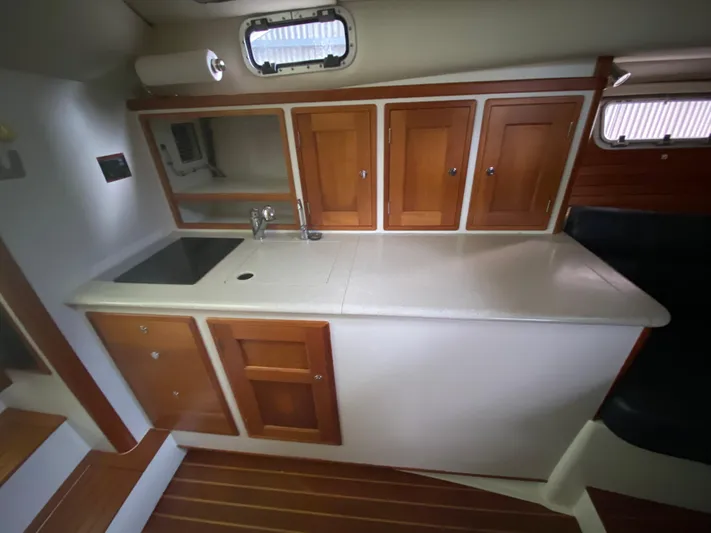 Saline Yacht Photos Pics 2005 MJM 34z Downeast boat interior with wooden cabinets and countertop.