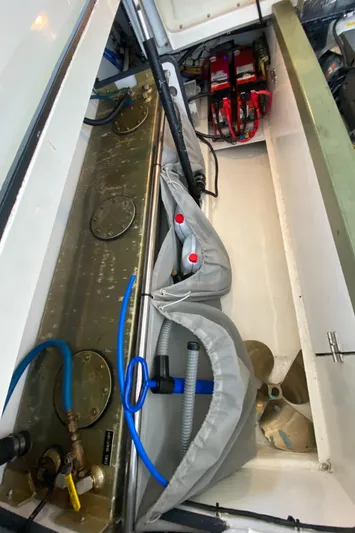 Saline Yacht Photos Pics Engine compartment of a 2005 MJM 34z Downeast boat, showing batteries and hoses.