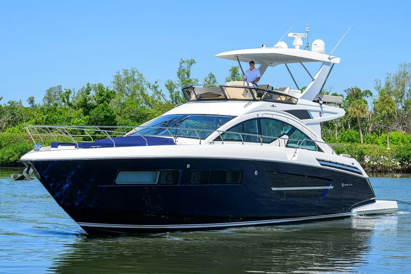 Unorthodocs Yacht Photos Pics 2018 Cruisers 60 Cantius Fly yacht cruising on a serene waterway.