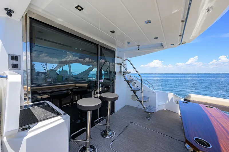 Unorthodocs Yacht Photos Pics 2018 Cruisers 60 Cantius Fly yacht deck with bar stools and ocean view.
