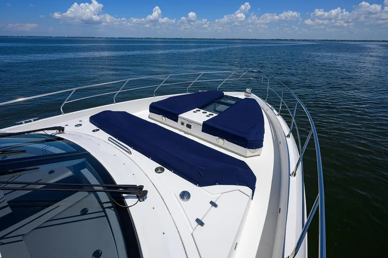 Unorthodocs Yacht Photos Pics 2018 Cruisers 60 Cantius Fly yacht with blue sun pads on open water.