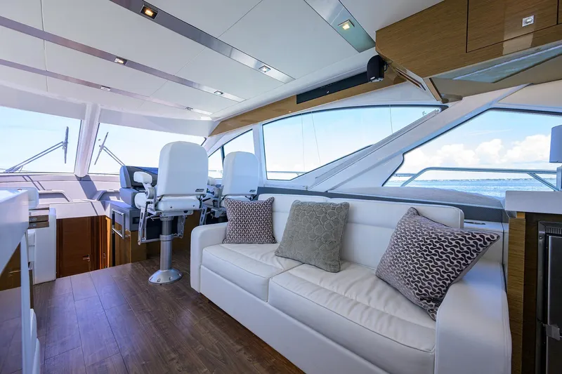 Unorthodocs Yacht Photos Pics Luxurious interior of 2018 Cruisers 60 Cantius Fly yacht with plush seating and ocean view.
