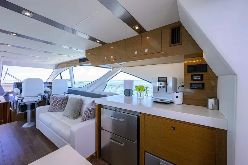 Unorthodocs Yacht Photos Pics Luxurious interior of 2018 Cruisers 60 Cantius Fly yacht with modern kitchen and seating area.