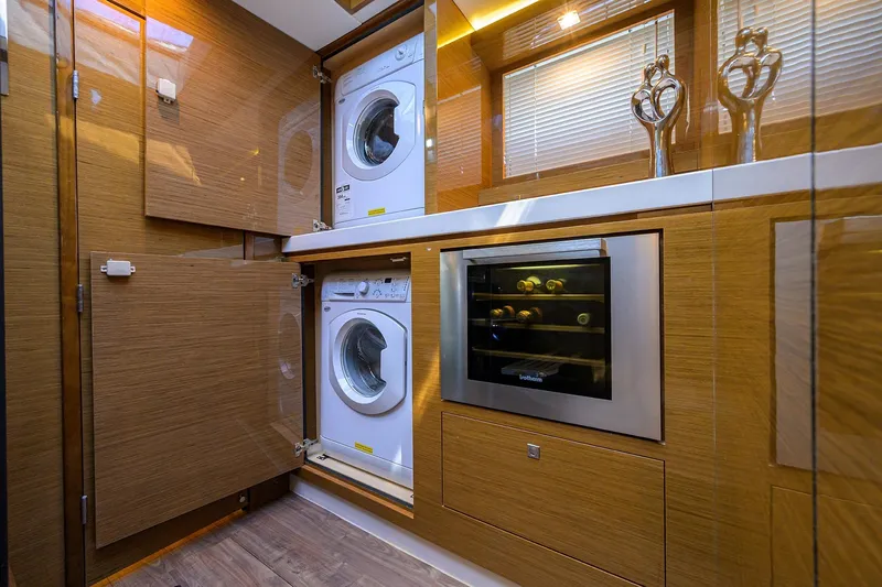 Unorthodocs Yacht Photos Pics Laundry and wine storage area on 2018 Cruisers 60 Cantius Fly yacht.