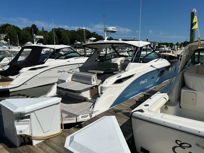  Yacht Photos Pics 2021 Sea Ray 320 DA docked at a marina on a sunny day.