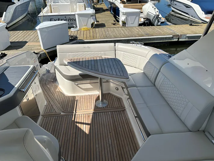  Yacht Photos Pics Luxury seating area on a 2021 Sea Ray 320 DA yacht at a marina.