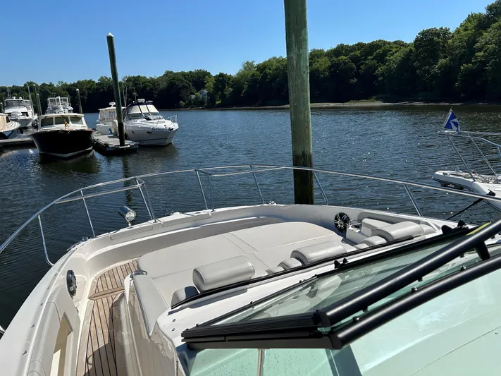  Yacht Photos Pics Sea Ray 320 DA 2021 model docked in a serene marina with other boats.