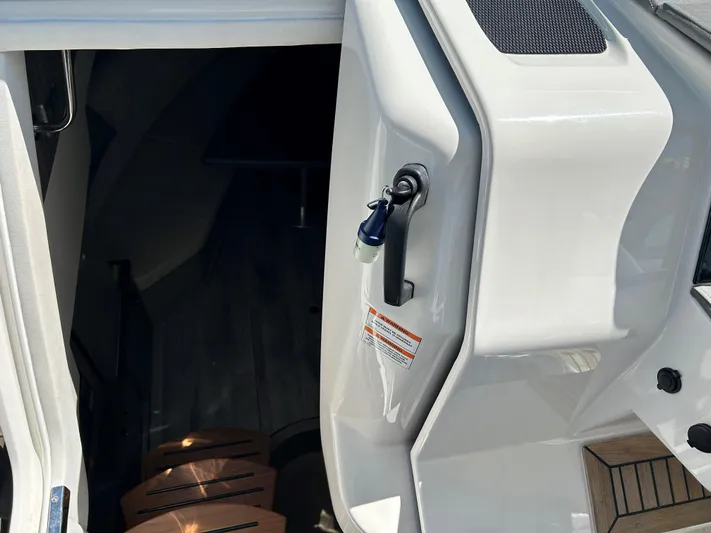  Yacht Photos Pics 2021 Sea Ray 320 DA cabin entrance with wooden steps and sleek white finish.