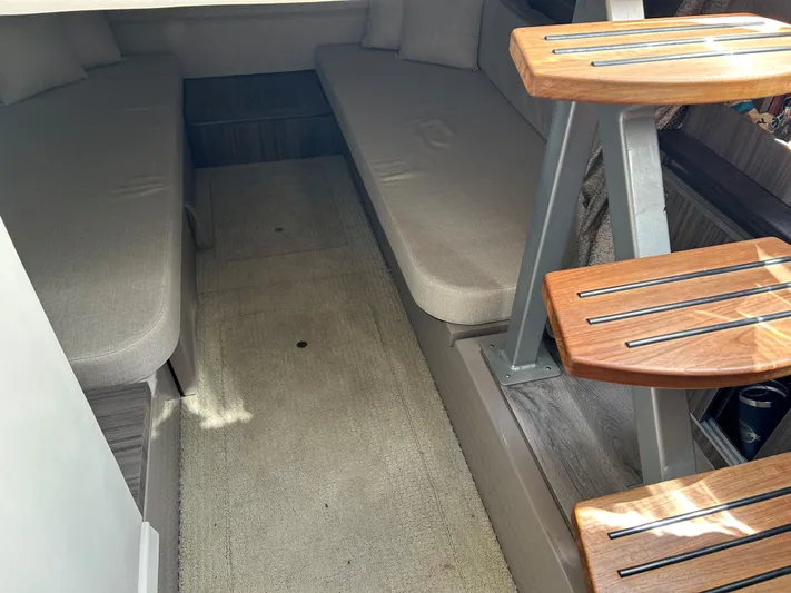 Yacht Photos Pics Interior cabin of 2021 Sea Ray 320 DA with cushioned seating and wooden steps.