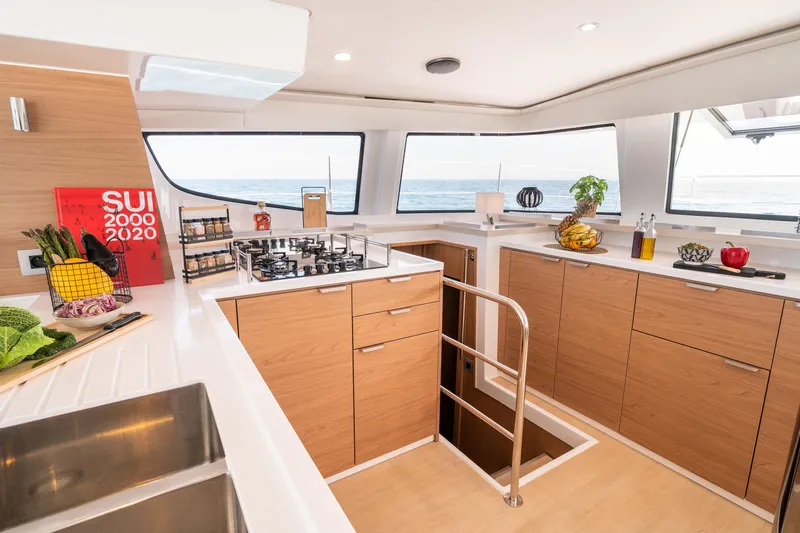 Azurea Yacht Photos Pics Modern kitchen interior on Bali 4.6 yacht, featuring wooden cabinets and ocean view, 2026 model.