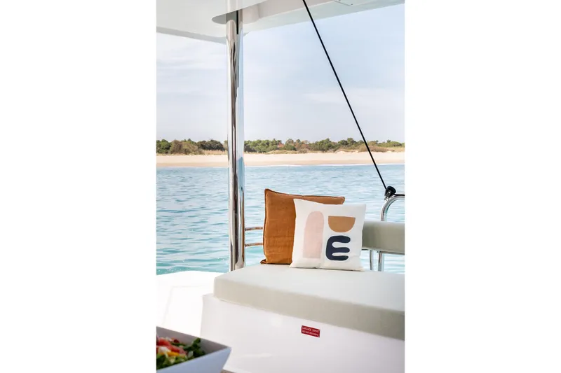 Azurea Yacht Photos Pics Cozy seating on Bali 4.6 yacht, 2026 model, with ocean view and decorative pillows.