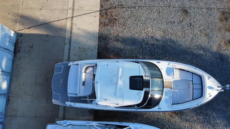  Yacht Photos Pics Overhead view of 2016 Chaparral 337SSX boat on gravel and concrete surface.