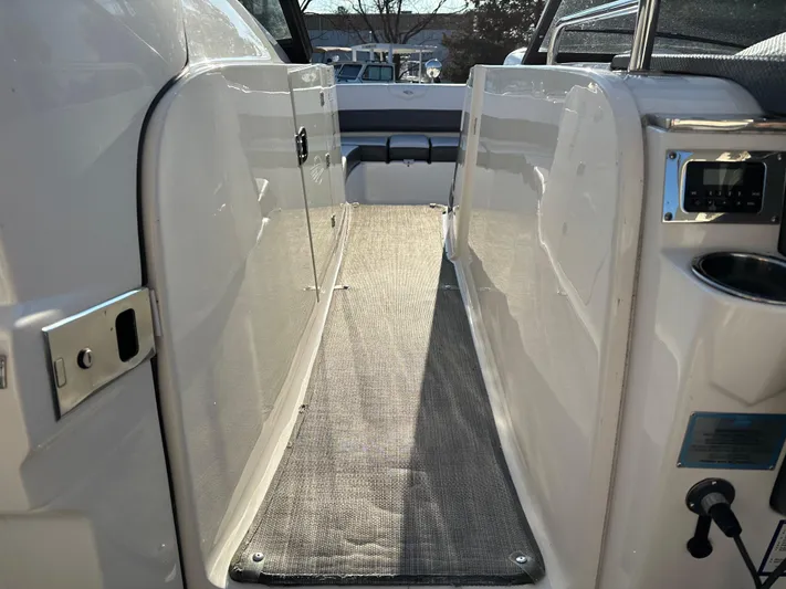  Yacht Photos Pics 2016 Chaparral 337SSX boat interior walkway with carpet and seating area.