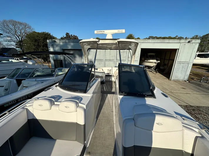  Yacht Photos Pics 2016 Chaparral 337SSX boat docked, featuring sleek design and spacious seating.