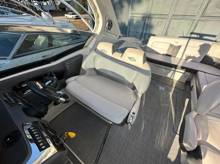  Yacht Photos Pics 2016 Chaparral 337SSX boat interior with steering wheel and seating area.
