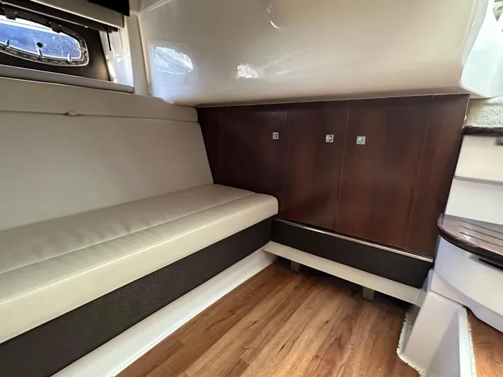  Yacht Photos Pics Interior of 2016 Chaparral 337SSX boat with beige seating and wooden cabinetry.
