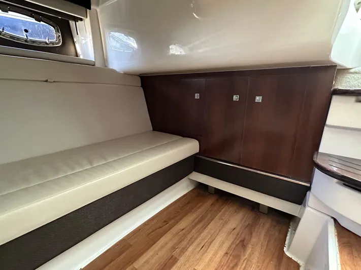  Yacht Photos Pics Interior of 2016 Chaparral 337SSX boat with seating and wooden cabinetry.