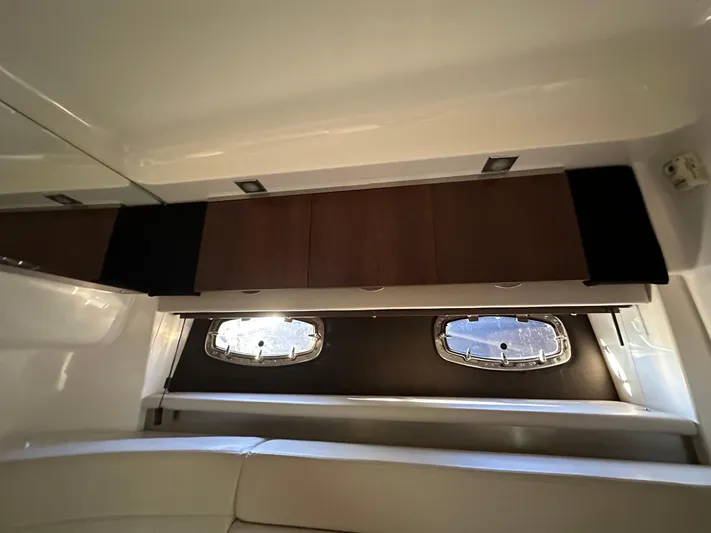  Yacht Photos Pics Interior cabin of 2016 Chaparral 337SSX boat with windows and storage cabinets.