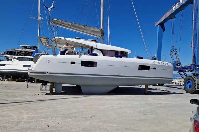 Eadan Doire Yacht Photos Pics 2017 Lagoon 42 catamaran on dry dock, with clear blue sky background.