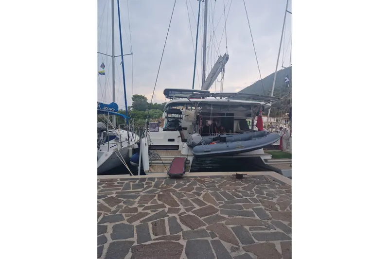 Eadan Doire Yacht Photos Pics 2017 Lagoon 42 catamaran docked at marina with inflatable boat on deck.