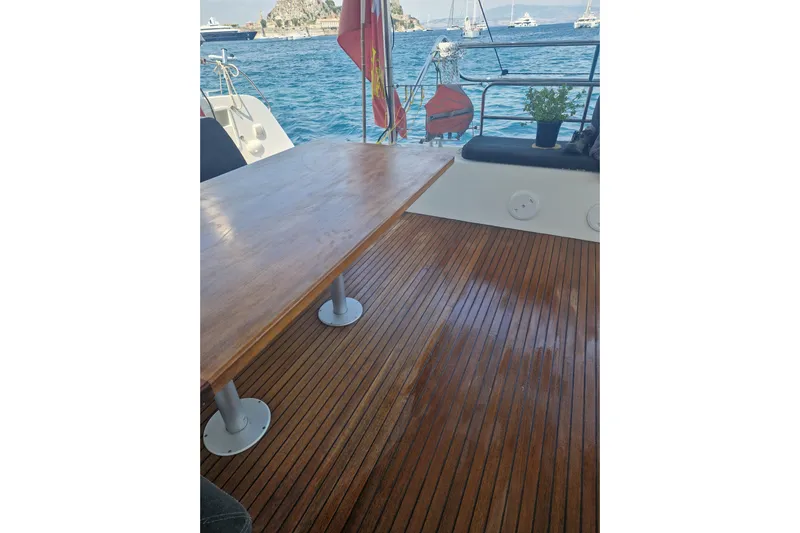 Eadan Doire Yacht Photos Pics Teak deck of 2017 Lagoon 42 catamaran with wooden table, ocean view.