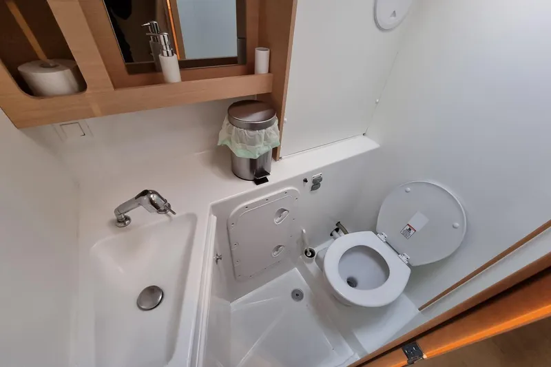 Eadan Doire Yacht Photos Pics Bathroom interior of a 2017 Lagoon 42 yacht, featuring sink, toilet, and storage.