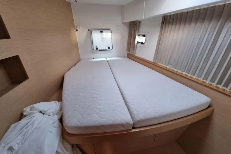 Eadan Doire Yacht Photos Pics Interior cabin of 2017 Lagoon 42 catamaran with double bed and porthole window.
